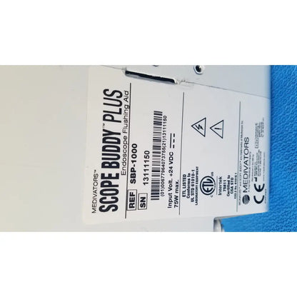 White rectangular label with black text on medivators scope buddy plus endoscope flushing aid model sbp-1000 product
