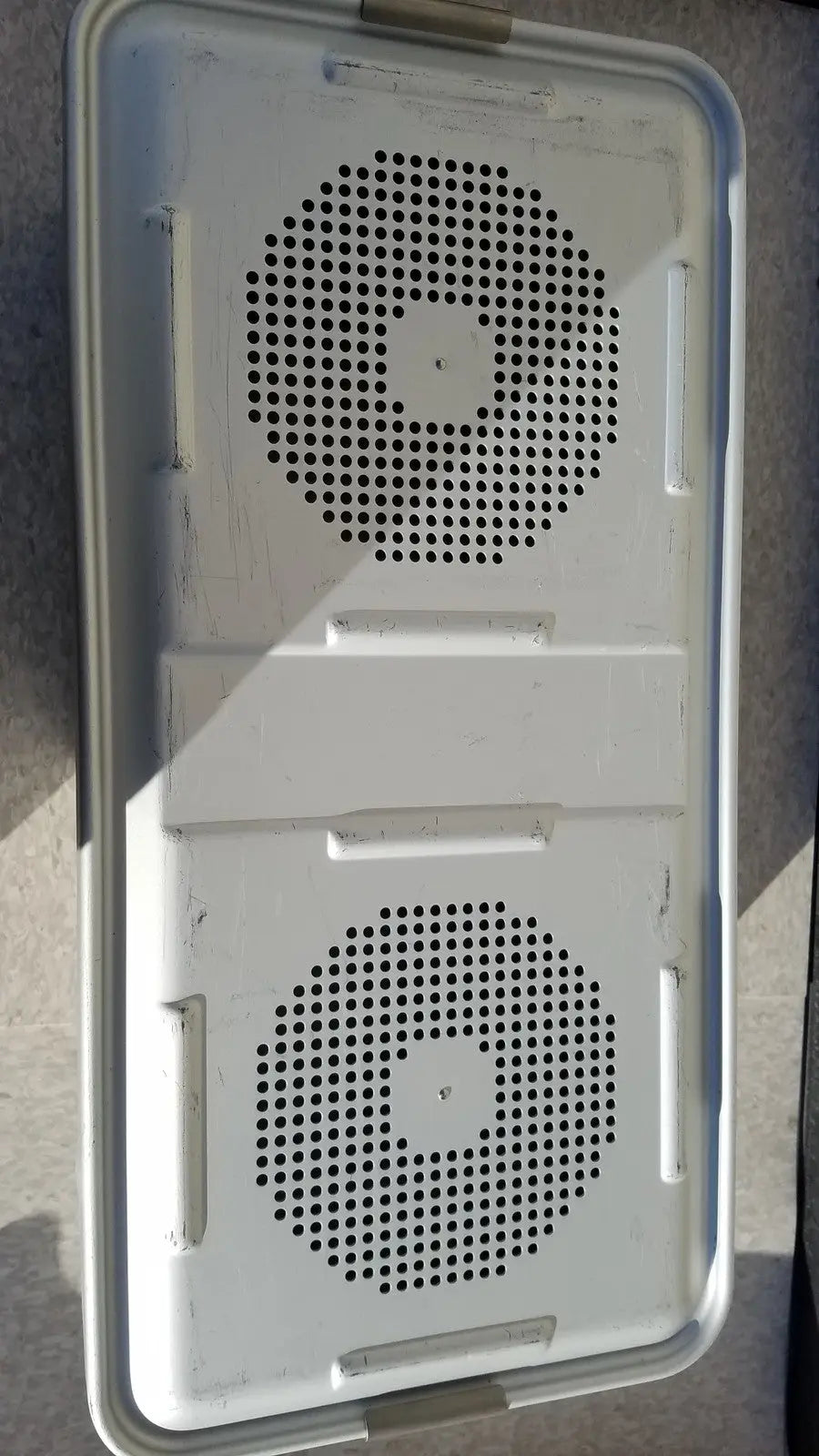 White plastic container with two circular perforated sections and handle for medline aluminum storage and sterilization use