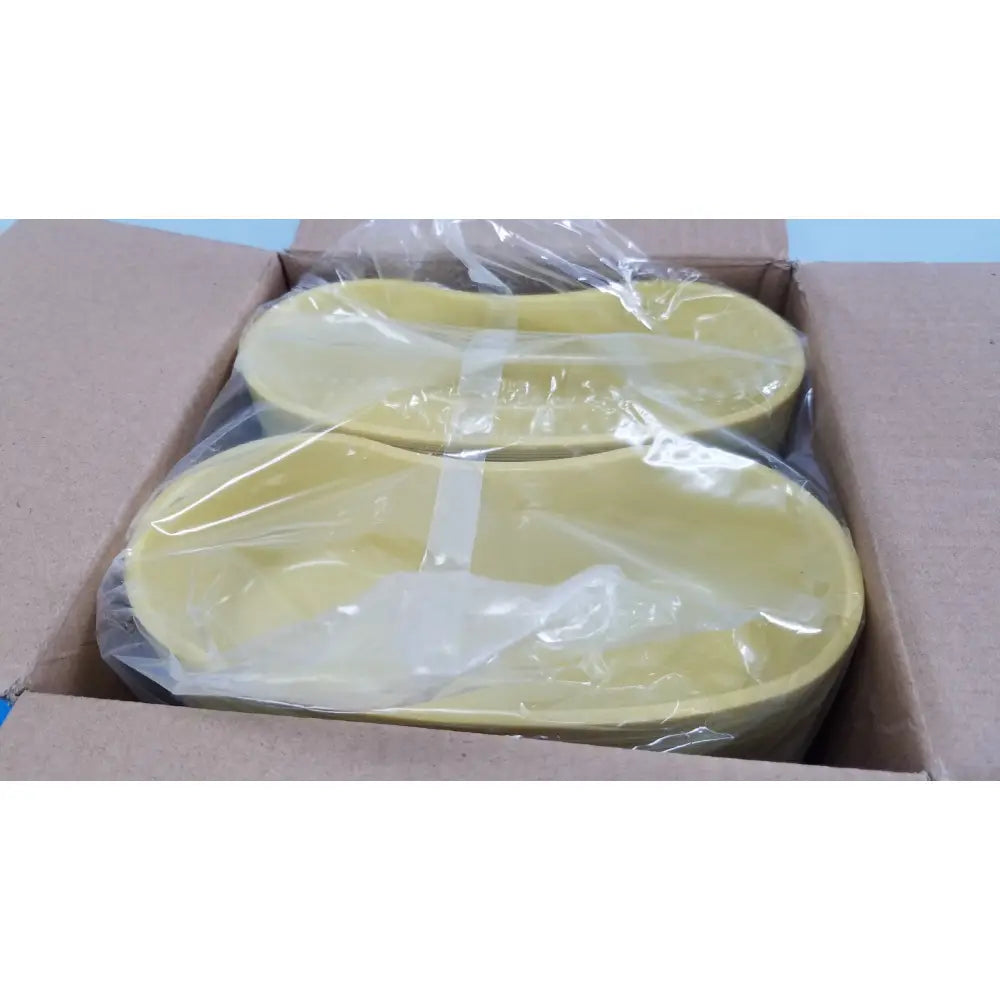 Two pale yellow oval-shaped plastic medline emesis basins gold 500 ml kidney dishes wrapped in clear plastic inside a box