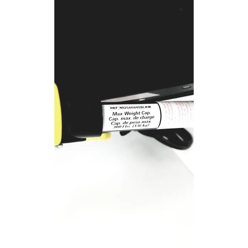 Black and yellow safety harness strap with white label showing max weight capacity on medline rolling walker mds8684gblkm