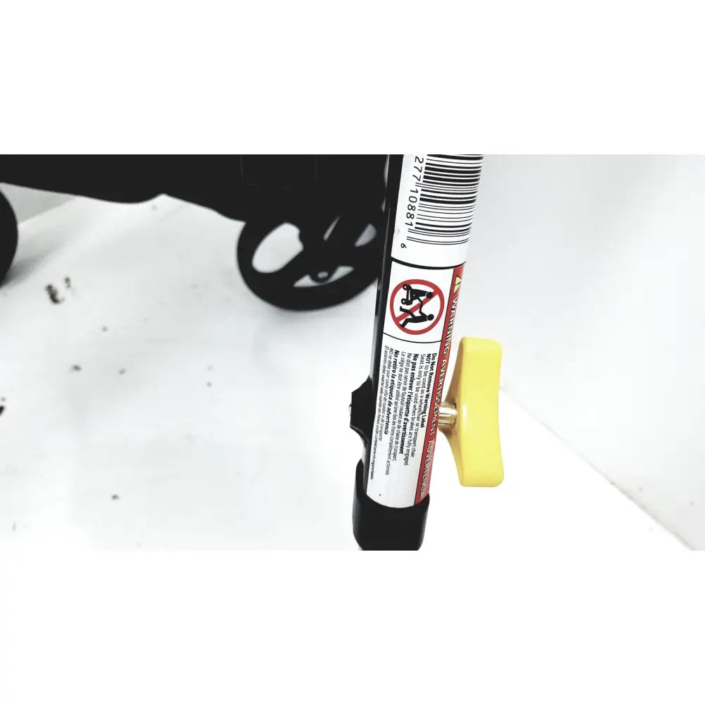 Yellow plastic handle with warning label on black medline rolling walker mds8684gblkm with hand brakes and cable light