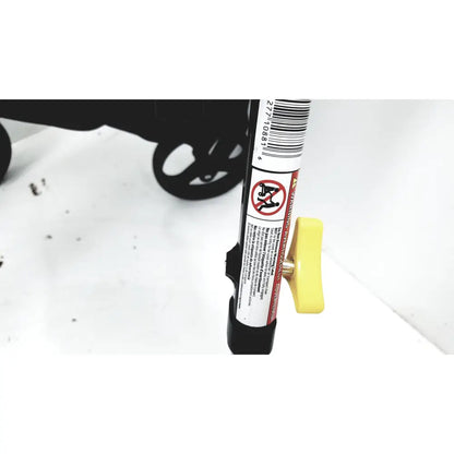 Yellow plastic handle with warning label on black medline rolling walker mds8684gblkm with hand brakes and cable light