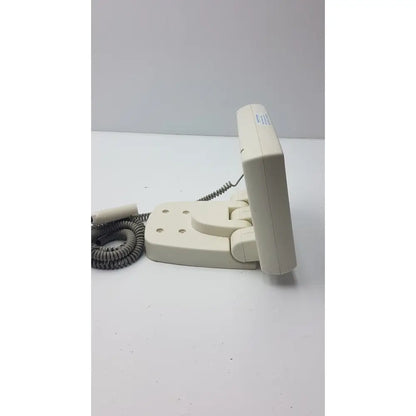 Cream-colored plastic wall-mounted telephone with coiled gray cord on Medrad Mark V ProVis RD injector control panel power console