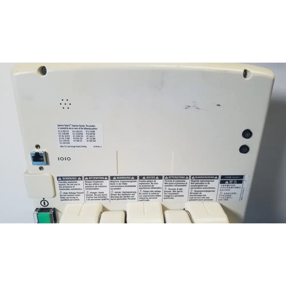 White plastic network switch blue ethernet port with warning labels on back of medrad spectris solaris ep mr contrast injector system monitor