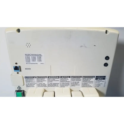 White plastic network switch blue ethernet port with warning labels on back of medrad spectris solaris ep mr contrast injector system monitor