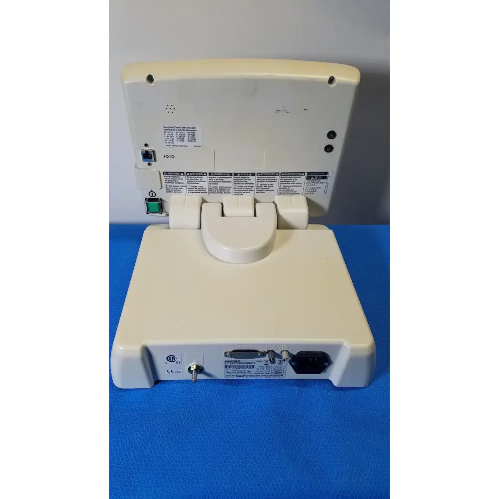 Cream-colored plastic back view of medrad spectris solaris EP MR contrast injector system monitor with hinged base and multiple ports