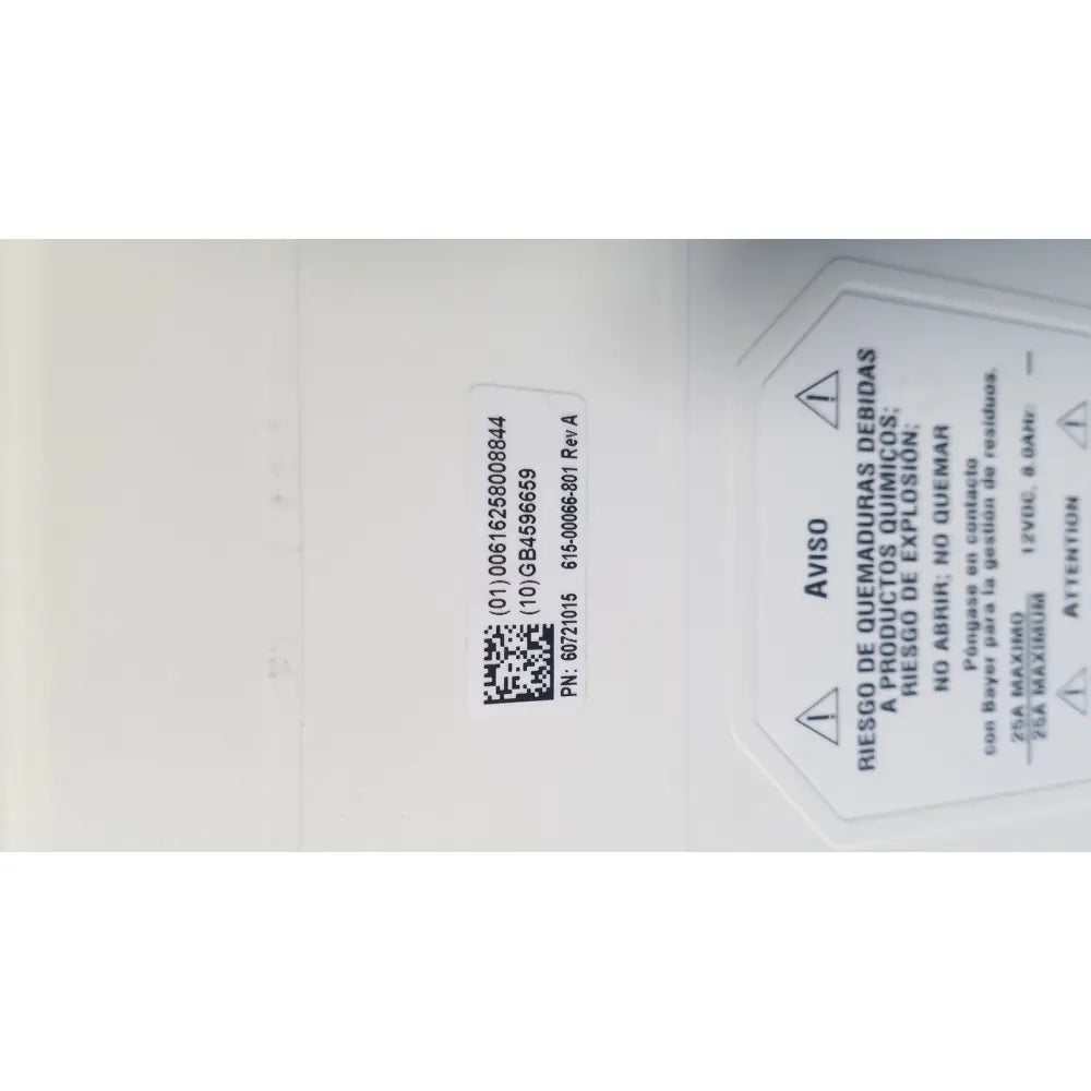 White rectangular safety label with chemical warnings in spanish and english on medrad spectris solaris mr injection battery