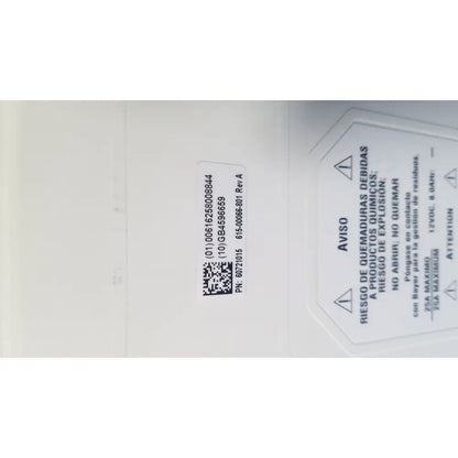 White rectangular safety label with chemical warnings in spanish and english on medrad spectris solaris mr injection battery