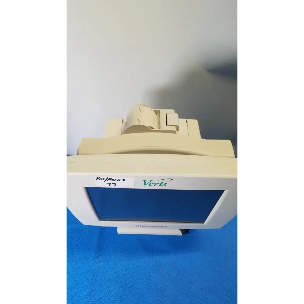 Beige Medrad Veris monitoring system terminal with white bezel and blue screen for advanced medical monitoring