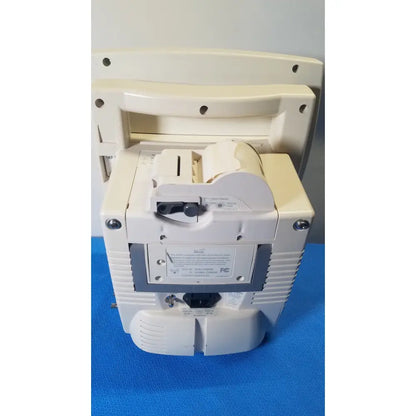 Cream-colored plastic cash register with paper roll and receipt slot for medrad veris monitoring system use