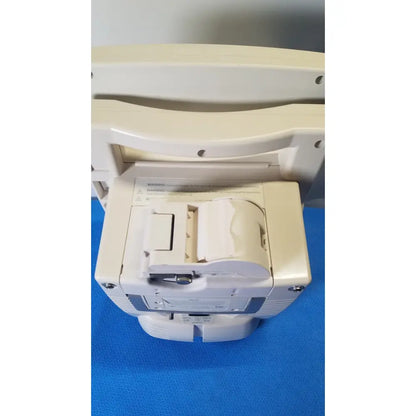 Beige medrad veris monitoring system showing back side with paper roll compartment and warning label