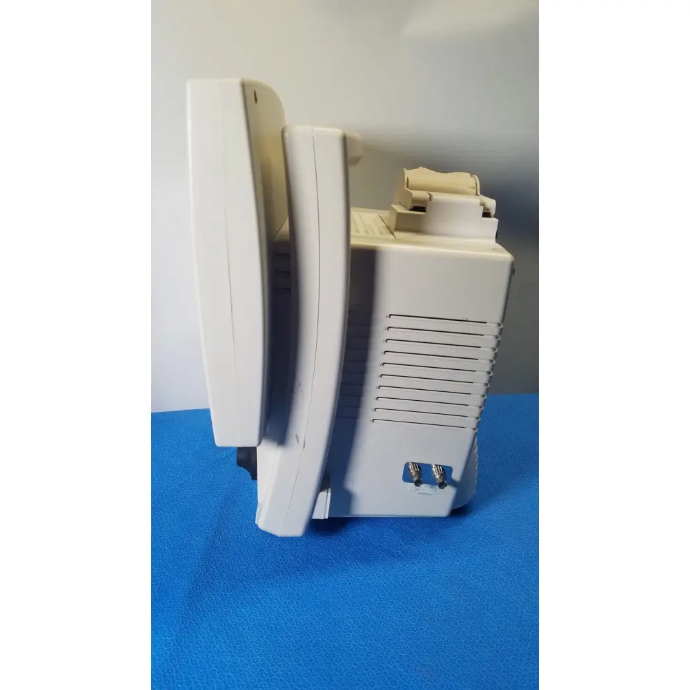 White plastic medrad veris monitoring system with beige control panel and side ventilation slits for reuse medical use