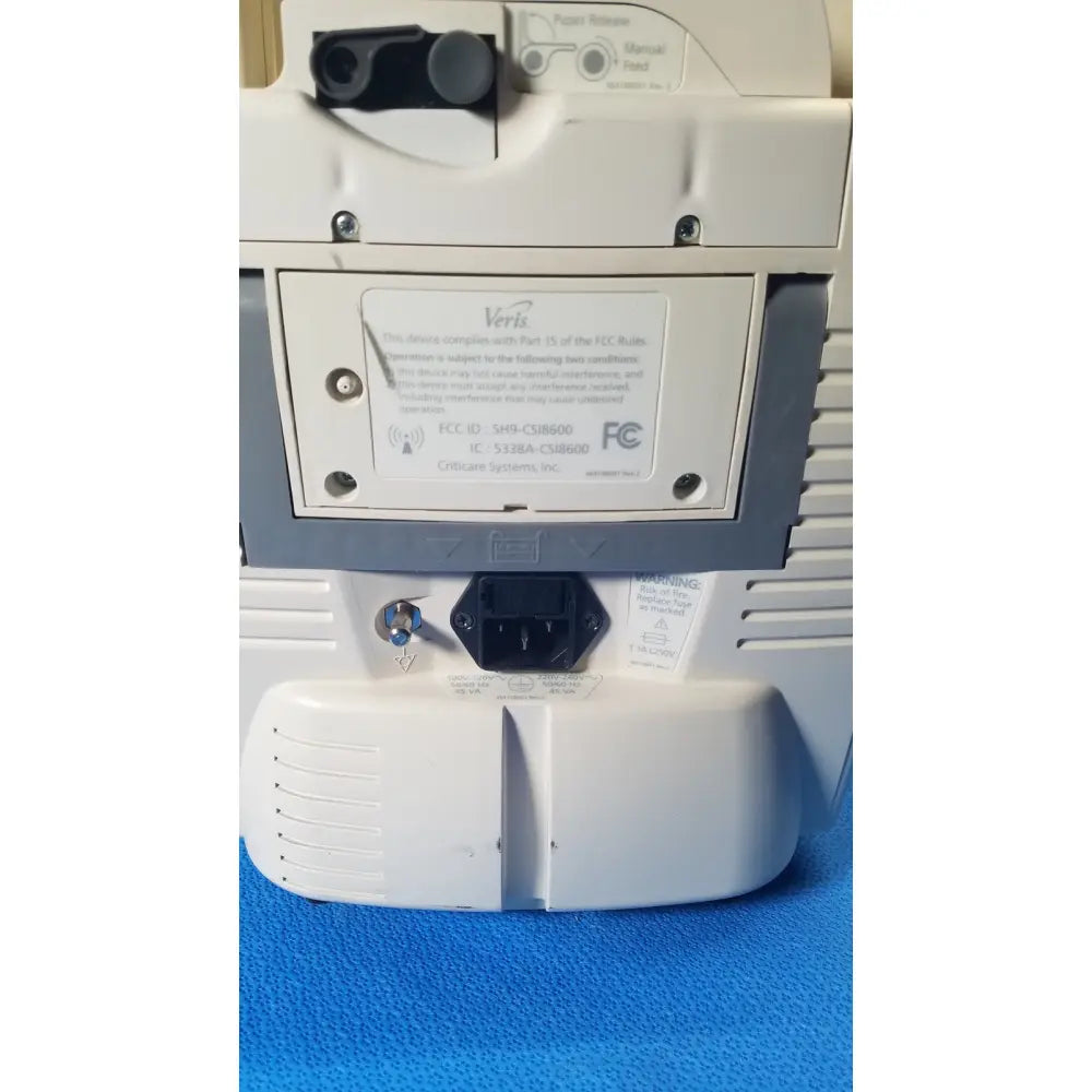 White plastic verisign modem with black power input port and regulatory labels at the back of medrad veris monitoring system