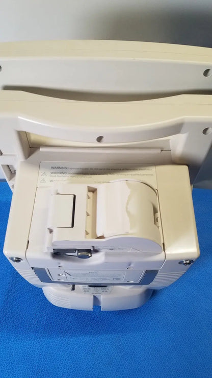 Beige medrad veris monitoring system showing back side with paper roll compartment and warning label