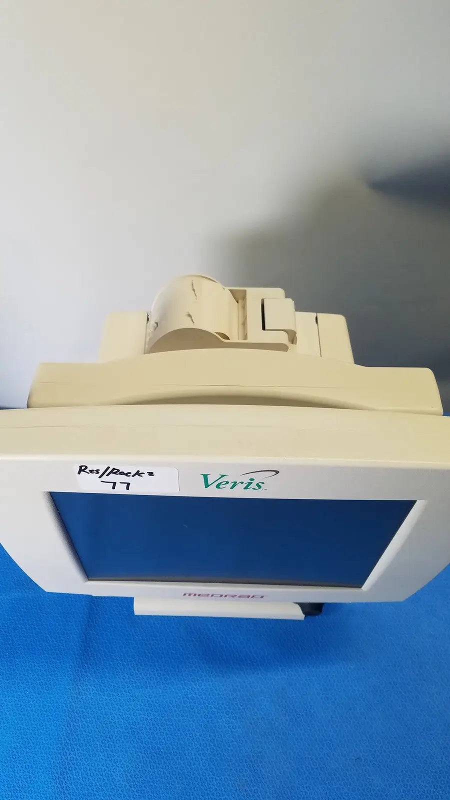 Beige Medrad Veris monitoring system terminal with white bezel and blue screen for advanced medical monitoring
