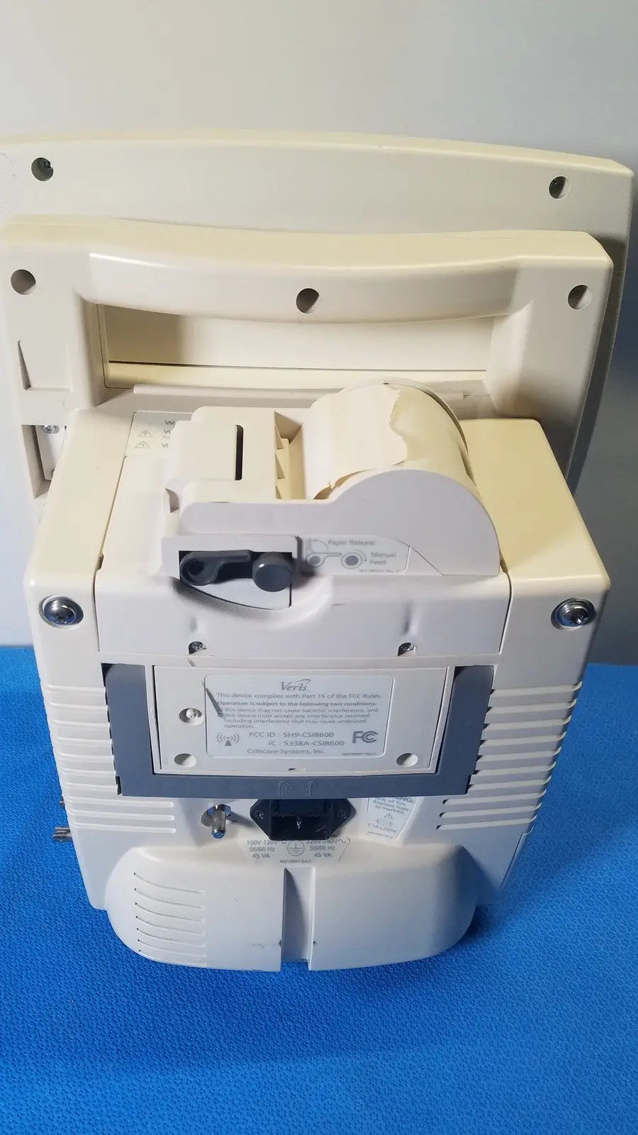 Cream-colored plastic cash register with paper roll and receipt slot for medrad veris monitoring system use