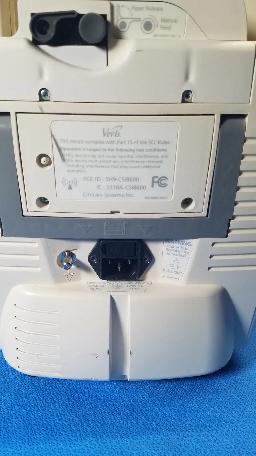 White plastic verisign modem with black power input port and regulatory labels at the back of medrad veris monitoring system