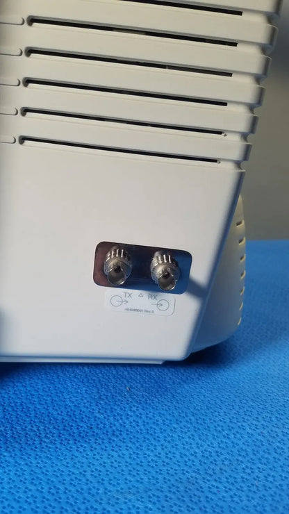 White plastic medrad veris monitoring system device back with two silver coaxial connectors labeled tx and rx for reuse medical use