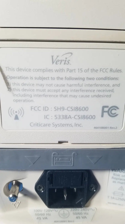 White plastic label with black text and veris logo showing fcc compliance on the back of medrad veris monitoring system for reuse medical use