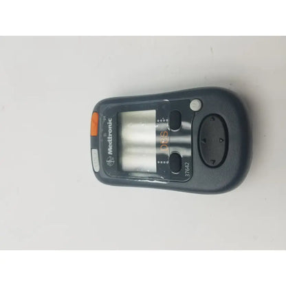 Black medtronic 37642 dbs patient programmer with orange accent button and digital display for dbs patient use
