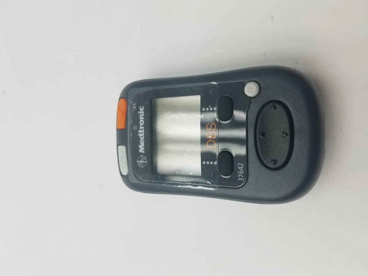 Black medtronic 37642 dbs patient programmer with orange accent button and digital display for dbs patient use