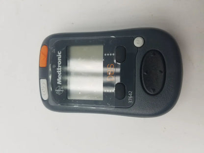 Black medtronic 37642 dbs patient programmer with orange and gray buttons for dbs patient device control