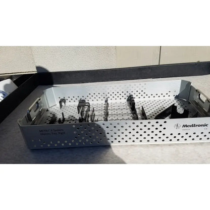 Silver perforated metal dilators tray with black clamps and medtronic logo for reuse medical sterilization trays