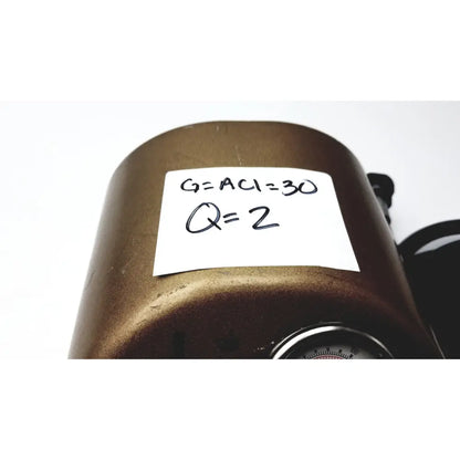 Bronze cylindrical pressure gauge with handwritten measurements on white label for midas rex legend gold pneumatic drill foot control unit
