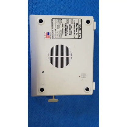 White plastic medtronic commander flex a4lite medical device back with circular vent grille and four mounting screws