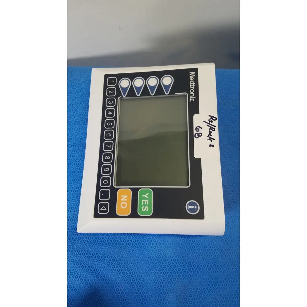 White rectangular medtronic commander flex cd320-gv patient monitor with black control panel and digital display screen