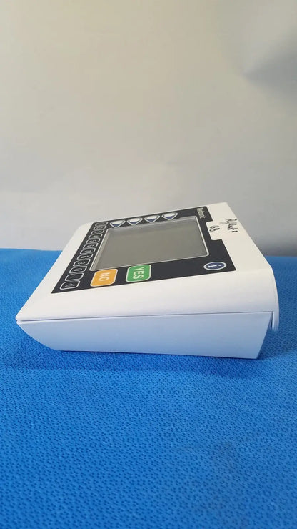 White plastic digital blood pressure monitor with black control panel and colored buttons by medtronic commander flex
