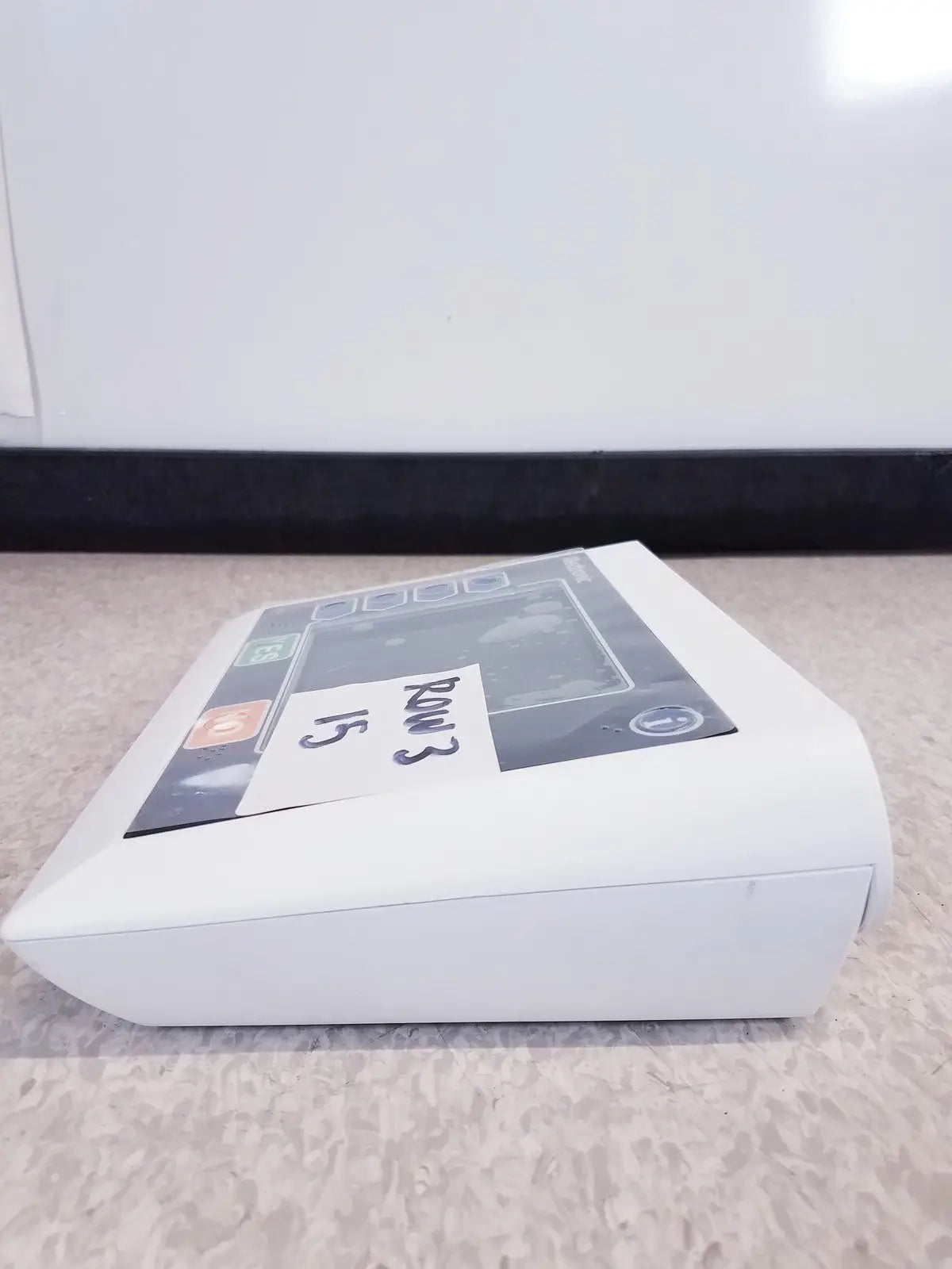 White rectangular electronic device with screen and buttons labeled rm3 15 featuring medtronic commander flex system cd315 untested