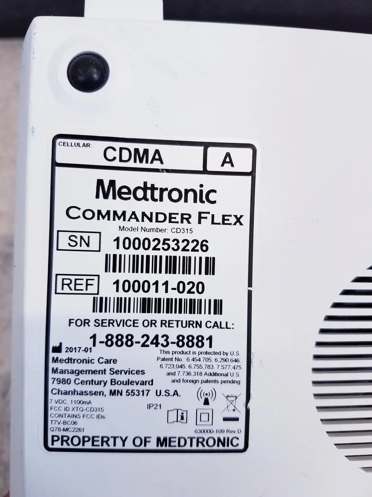 White medtronic commander flex cd315 cellular device with black label showing model and service info for reuse medical use