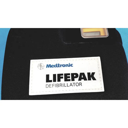 Black medtronic lifepak 1000 defibrillator with white label showing brand and model suitable for reuse medical with quik-pak pads