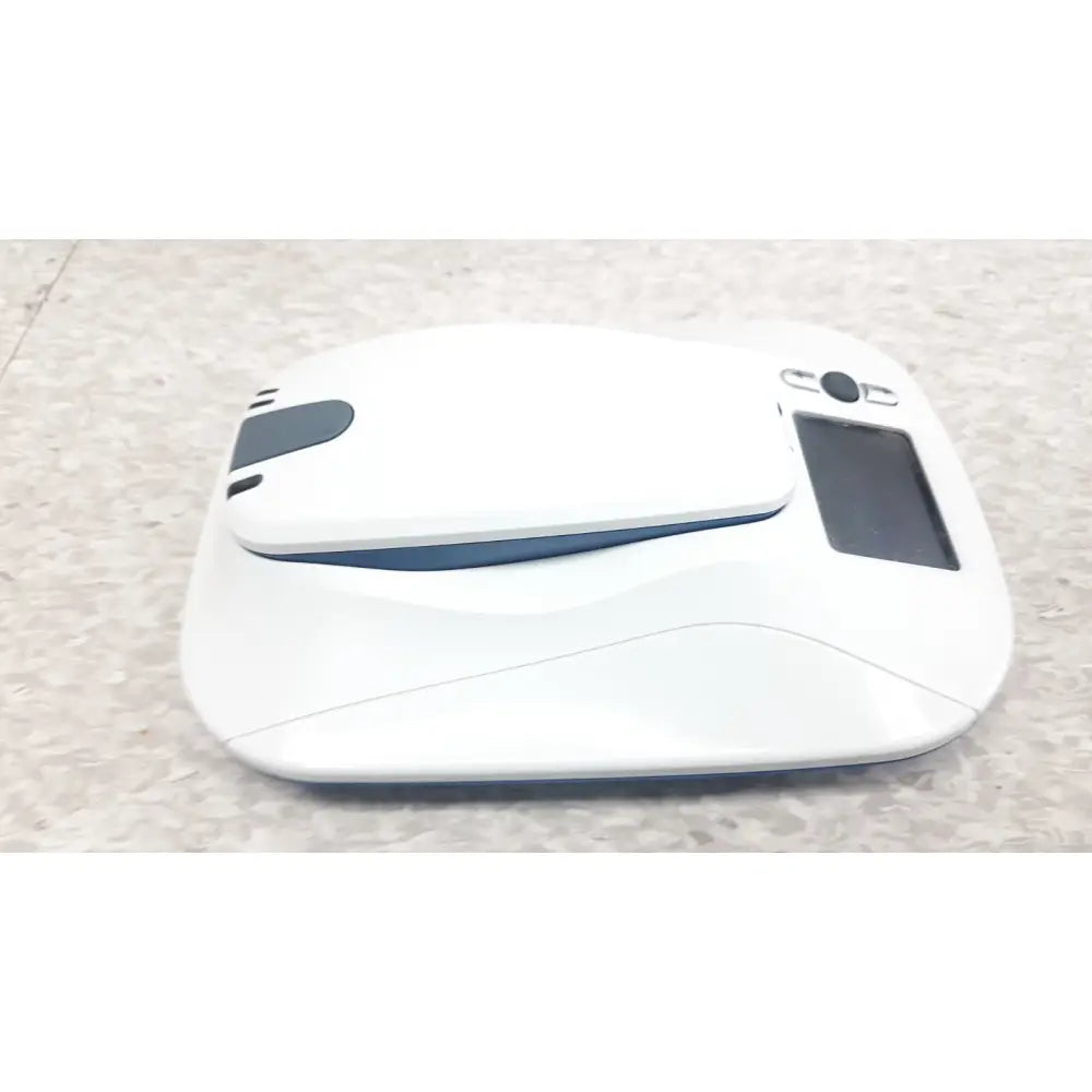 Medtronic mycarelink remote patient monitor model 24955 with sleek white and blue robotic vacuum cleaner design