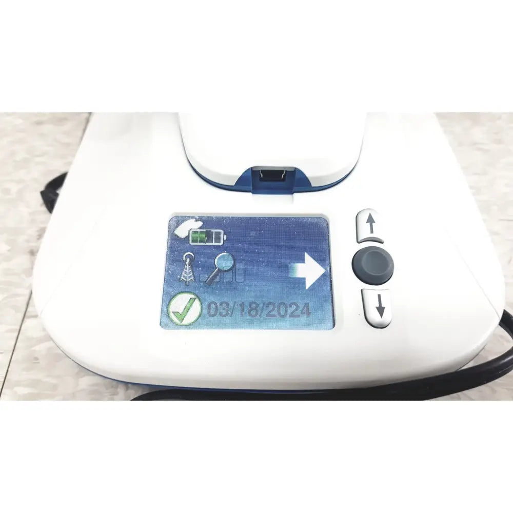 White and blue medtronic mycarelink remote handheld digital patient monitor displaying date battery and connectivity icons