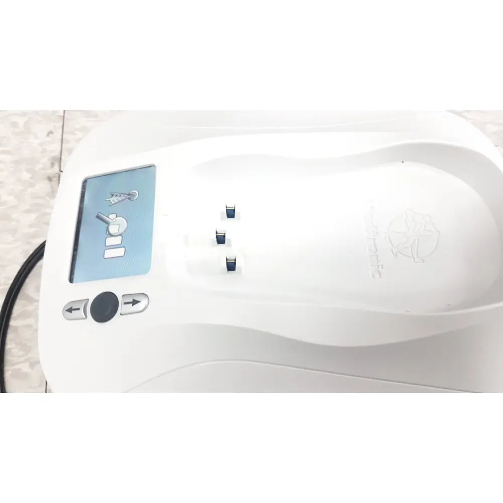 White plastic medtronic mycarelink remote patient monitor with digital display and three charging ports