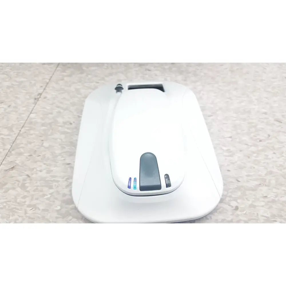White robotic vacuum cleaner with sleek design and blue indicator lights for medtronic mycarelink remote patient monitor use