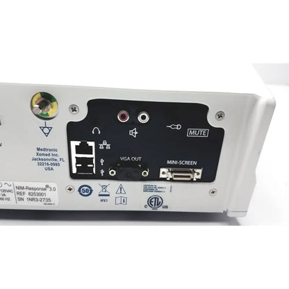 Back side of medtronic nim-response 3.0 white medical device with black panel featuring vga out mini-screen ports and mute button for reuse medical use