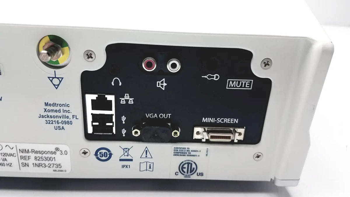 Back side of medtronic nim-response 3.0 white medical device with black panel featuring vga out mini-screen ports and mute button for reuse medical use