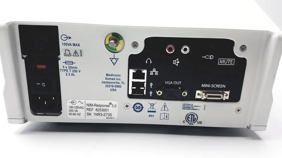 White medtronic nim-response 3.0 reuse medical device with black control panel and multiple ports on back side