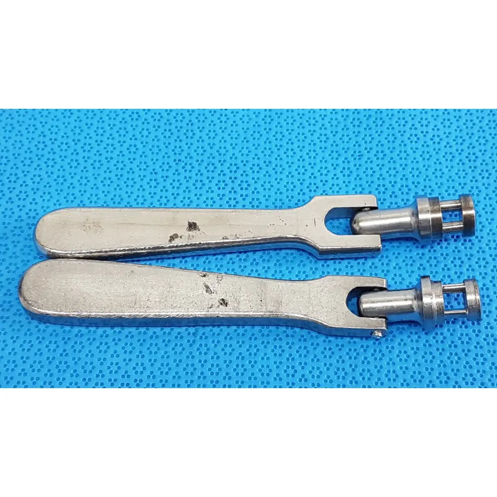 Two silver-toned metal medtronic octobase retractor handles with smooth slightly worn finish lot of 2 surgical components