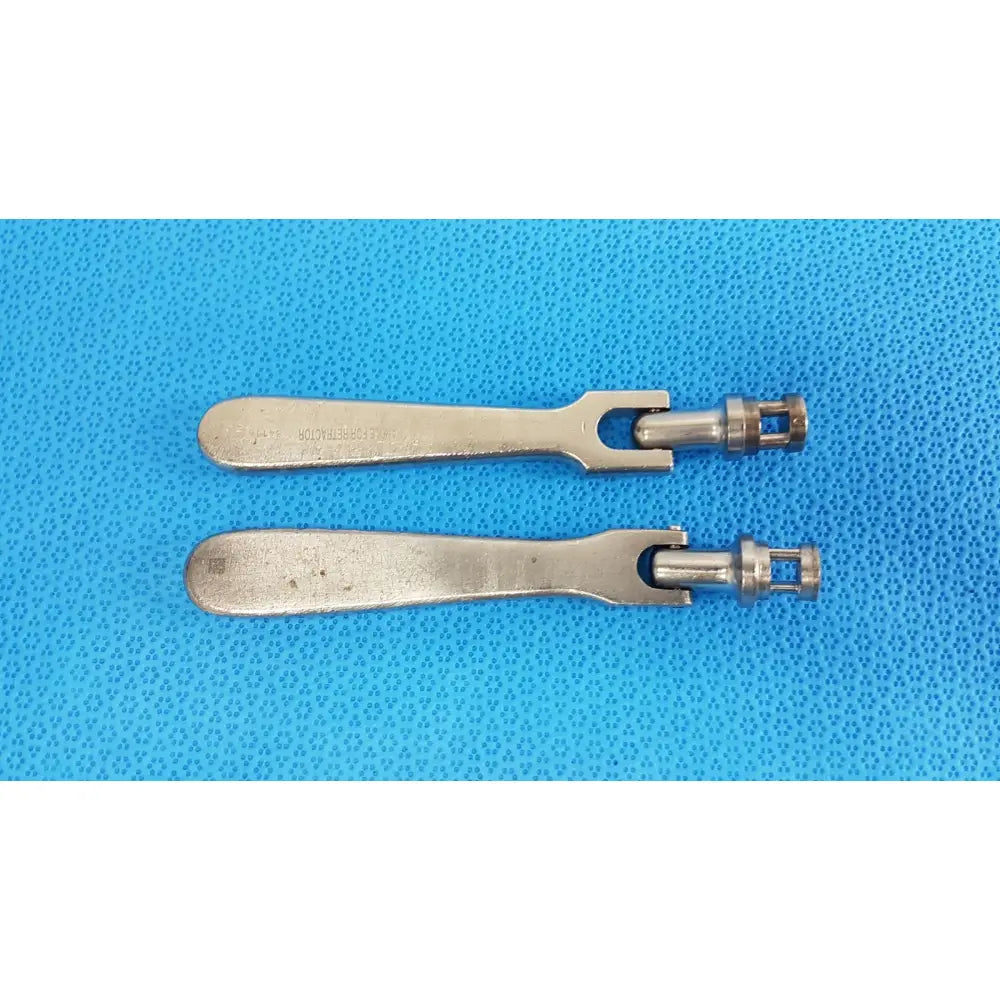 Two metallic silver-toned medtronic octobase retractor handles with flat elongated grips and central pivot for surgical use lot of 2