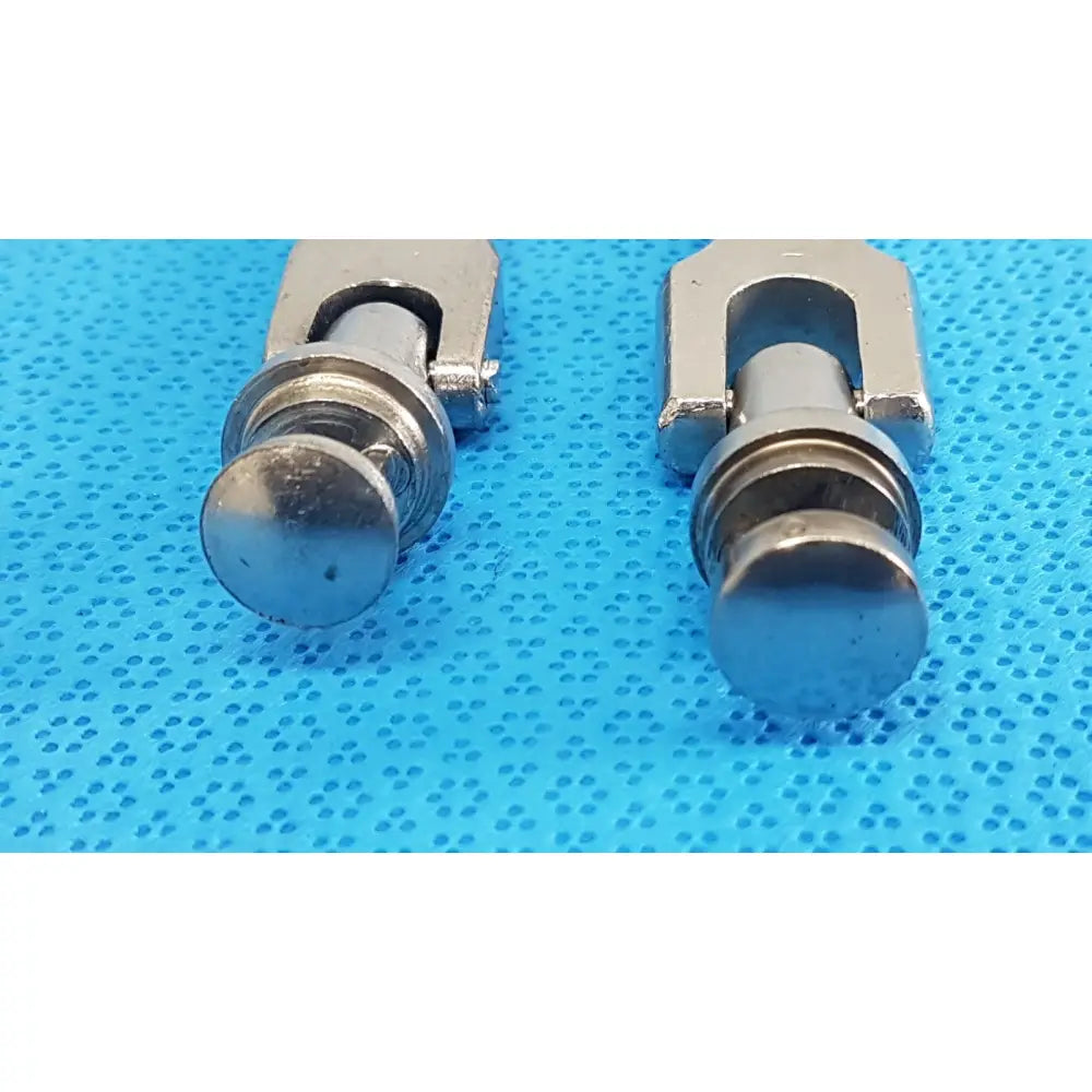Two metallic u-shaped medtronic octobase retractor handles with silver-toned textured cylindrical ends lot of 2