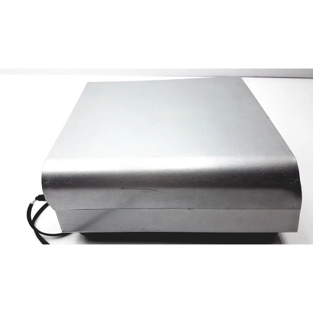 Silver metallic rectangular medtronic peak plasmablade pulsar ii generator with rounded edges and black cable attached