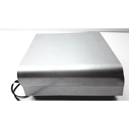 Silver metallic rectangular medtronic peak plasmablade pulsar ii generator with rounded edges and black cable attached
