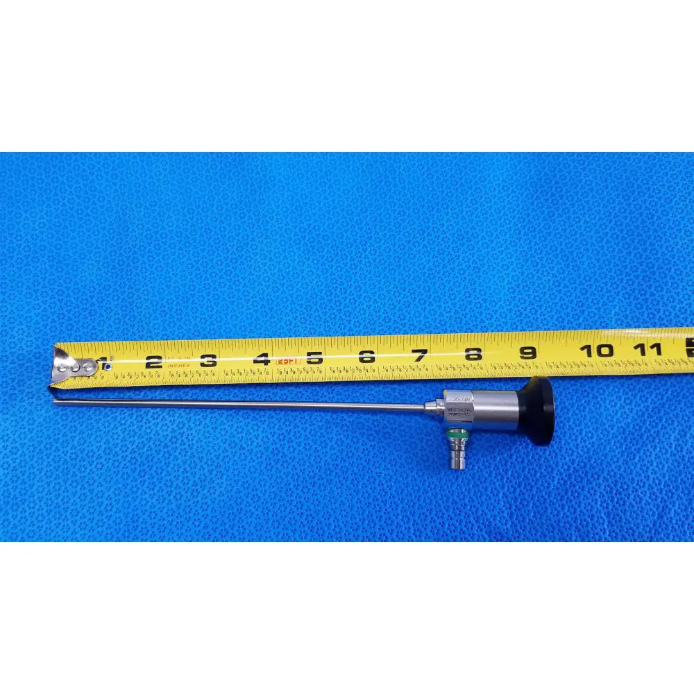 Silver medtronic sharpsite autoclavable 134°c endoscope with black handle and green connector beside yellow measuring tape