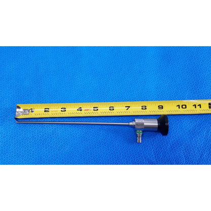 Silver medtronic sharpsite autoclavable 134°c endoscope with black handle and green connector beside yellow measuring tape