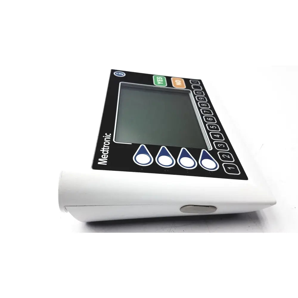 White medtronic insulin pump with black control panel and screen featuring numbered buttons and droplet icons medtronics commander flex