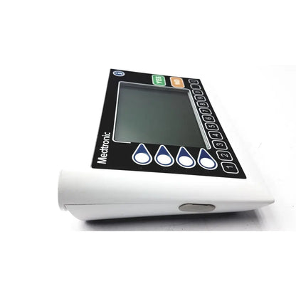 White medtronic insulin pump with black control panel and screen featuring numbered buttons and droplet icons medtronics commander flex